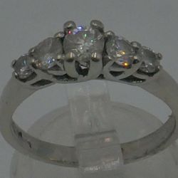 14KT WHITE GOLD ANNIVERSARY BAND SIZE 7.5 3.8 GRAMS WITH 5  DIAMONDS  APPROXIMATE - CENTER ROUND DIAMOND 0.30-0.35PTS SI2-H; 2 SIDE DIAMONDS 0.16-0.18