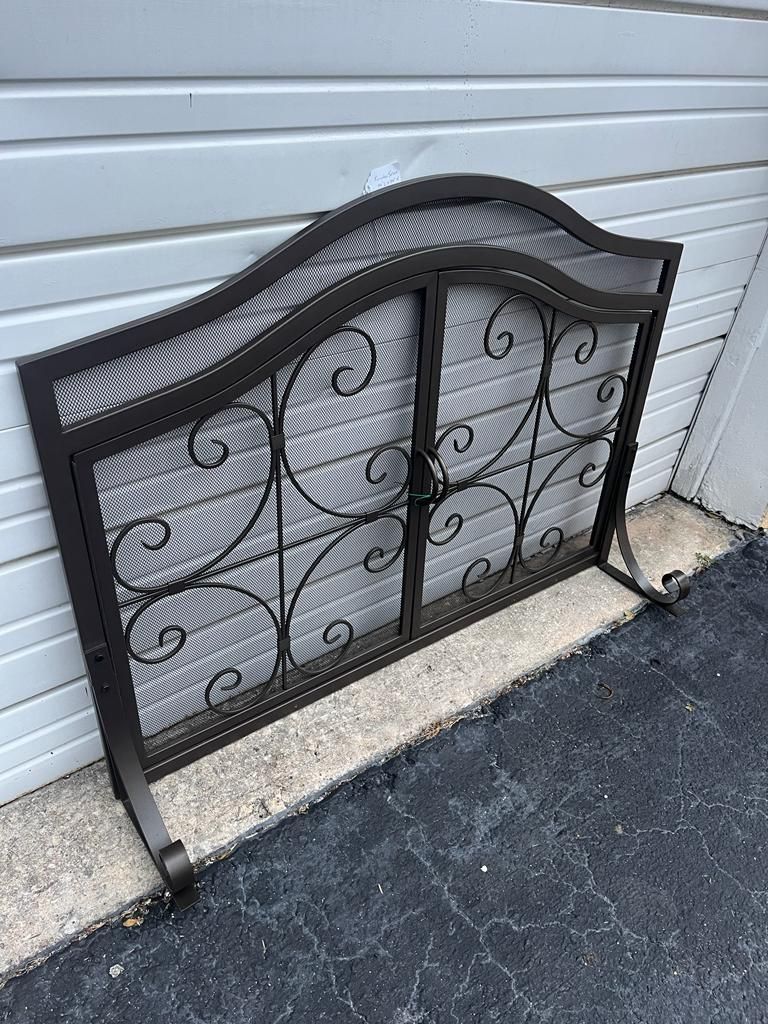 Gray metal fireplace screen with doors that open 44 x 34. Comes with 5 piece fire accessories set