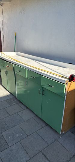 Green wooden cabinet with white counter top