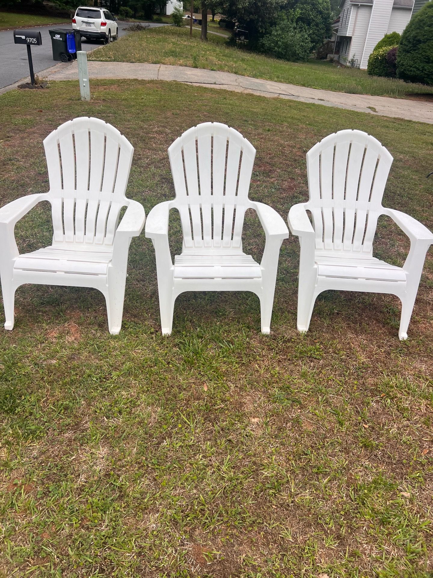 Three white plastic Adirondack Chairs
