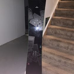 K2 Snowboard With Ride Bindings And A Carry Bag