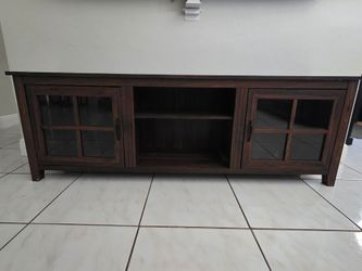 Modern farmhouse glass door TV stand in dark walnut.