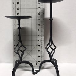 A pair of metal decorative candle holders