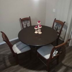 Solid wood dining table with ironwork and 4 chairs.