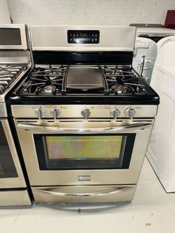 Frigidaire stainless steel natural gas stove; includes a receipt for a 90-day warranty.