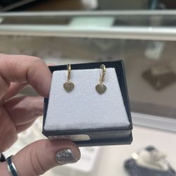 Small gold hoops with heart charms