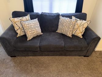 Grey couch with pillows
