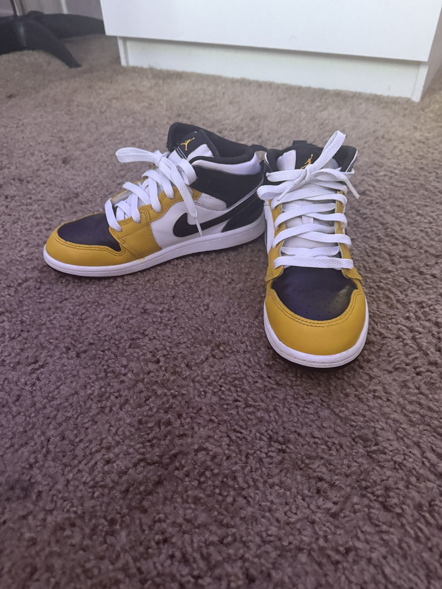 These Are Black,yellow, And White Air Jordan 1 Mids