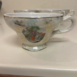 Vintage Kahla-style porcelain tea cup with light pinks and blue iridescent