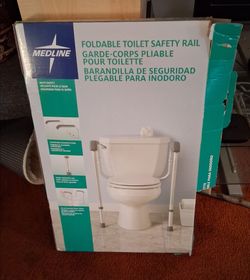 Midline foldable toilet safety rail