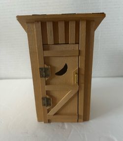 Vintage wooden two-seater outhouse designed for dollhouse or miniature village displays