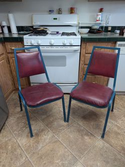 Two vintage heavy duty steel frame padded kitchen chairs