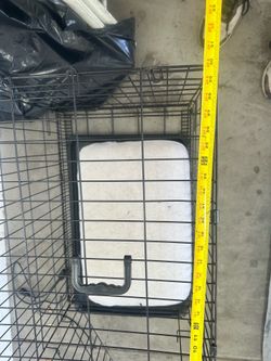 Foldable black metal dog crate in good condition.