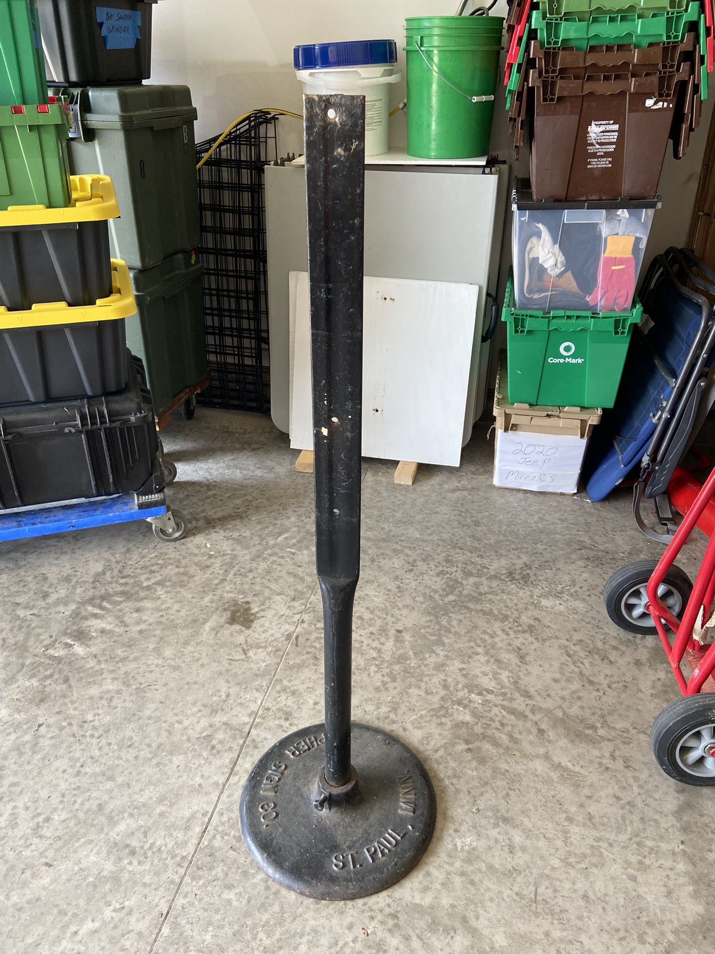 Sign post with cast-iron base approximately 4 feet tall