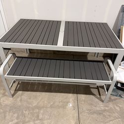Outdoor table with bench