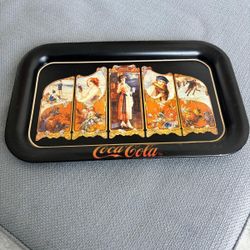 The item is a vintage Coca-Cola serving tray, a reproduction of a 1923 design …copyrighted  in 1990… 14 “ x 9”. $20