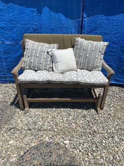 Teak rocking bench with cushions