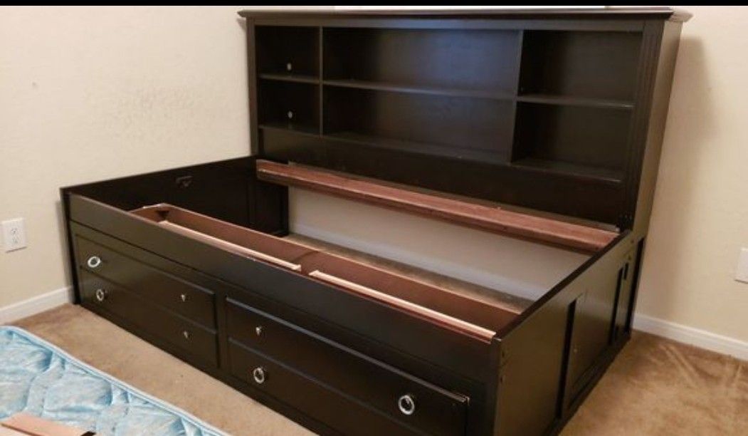 Twin daybed with bookshelves and 2 drawers.