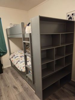 Gray twin over twin bunk bed with drawers and built-in bookcase