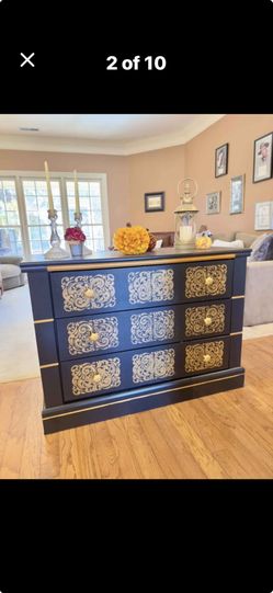 ELEGANT BLACK DRESSER AND GOLD ACCENTS WITH AN UNIQUE DESIGN.