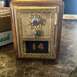 This is a handcrafted vintage post office box door bank.  