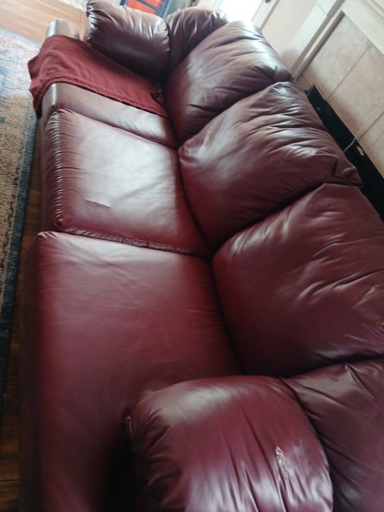 Two Piece Burgundy Leather Couch Set Has 4 Small Rips
