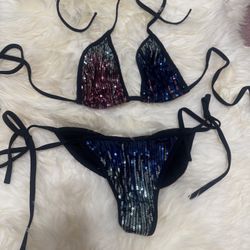 Eye-catching triangle bikini with multicolor sequin panels and black tie straps. Designed for a flattering fit and adjustable comfort. Shimmering sequ