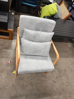 Brown Wood Lounge Chair with Light Gray Cushion and Pillow