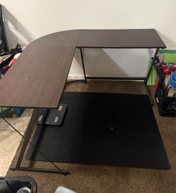 Brown Desk with Black Chair Mat
