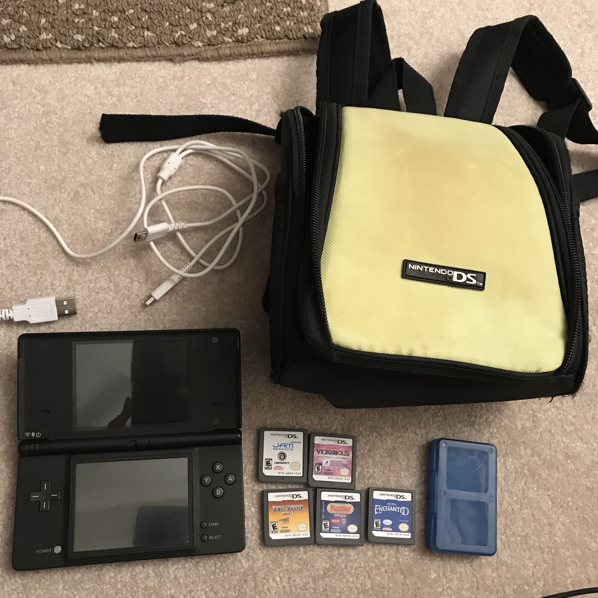 Nintendo dsi handheld system 5 games and carrying bag