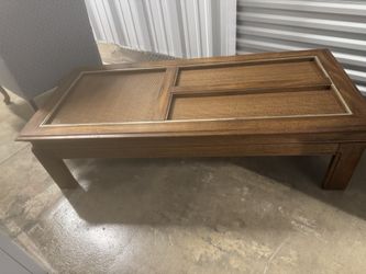  vintage coffee table walnut wood piece featuring  rattan inserts beneath glass panels, designed in a Mid -century modern style.     