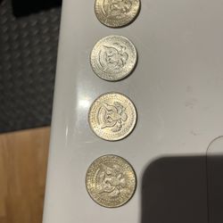 four 1964 kennedy half dollars . two good circulated condition . other two with interesting contrast . 90% silver 