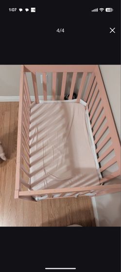 Pink mini crib