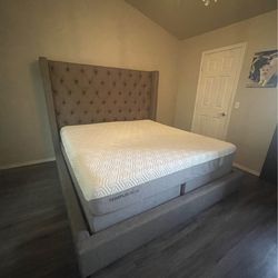 Grey upholstered king bed frame, no mattress or boxspring