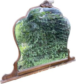 Vintage wood framed beveled mirror. Unusual shape