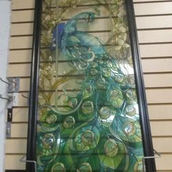 Glass Framed Peacock.