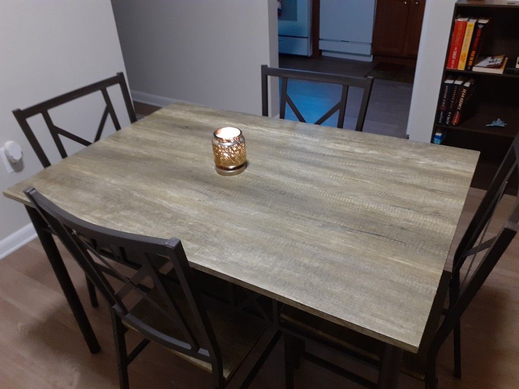 Fairly new dining room table. Seats 4 people. Does have a little damage but, not really visible.