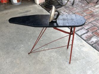 Antique child’s iron and ironing board