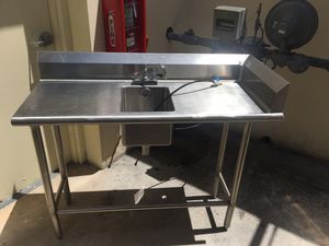 Photo Stainless steel work table with sink and faucet
