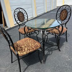 Small glass bistro dining table with 3 chairs ..30” high x 30 “ round … $100