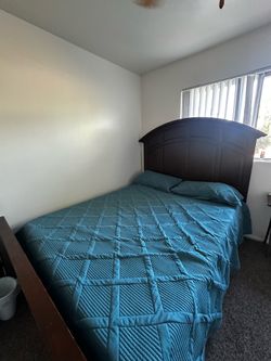 Wooden bed with the mattress