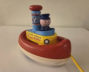 Vintage 1967 Fisher-Price Tuggy Tooter pull and bath toy.