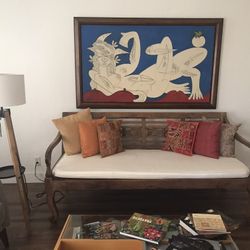 Pre-owned hand carved wood bench from Indonesia with cushions included. 