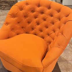 Orange button-tufted accent chair