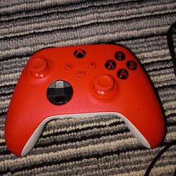 Red and white Xbox controller with builtin grip. Also  Rig headset with microphone attachment!