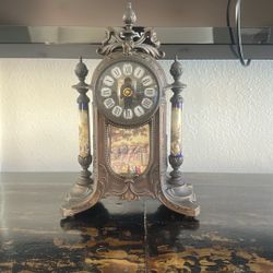 Ornate Vintage-Style Mantel Clock with Roman Numerals  Elegant vintage-style mantel clock featuring a decorative metal frame, Roman numeral dial, and 