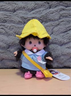 Monchhichi doll with a school girl outfit. Looks like “Punch” the monkey
