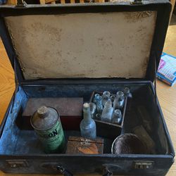Antique suitcase with items inside