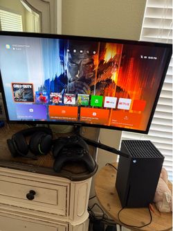 Xbox series X and controllers and monitor and headset