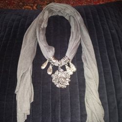 Necklace On A Grey Wraparound Neck Scarf 